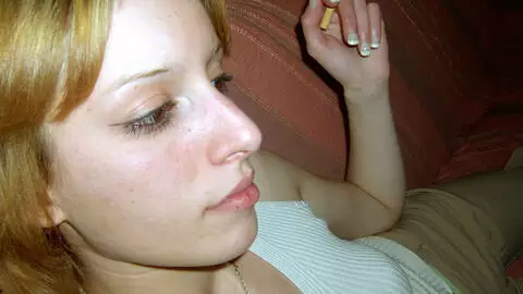 Little teen blonde posing and stripping on the sofa photo 2