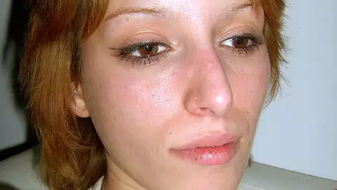 Little teen blonde posing and stripping on the sofa photo 4